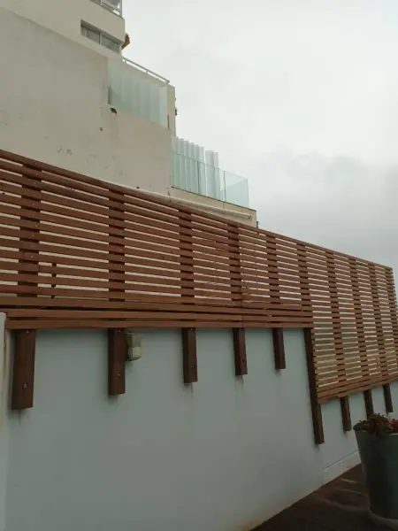 Timber slat railing along an elevated outdoor walkway