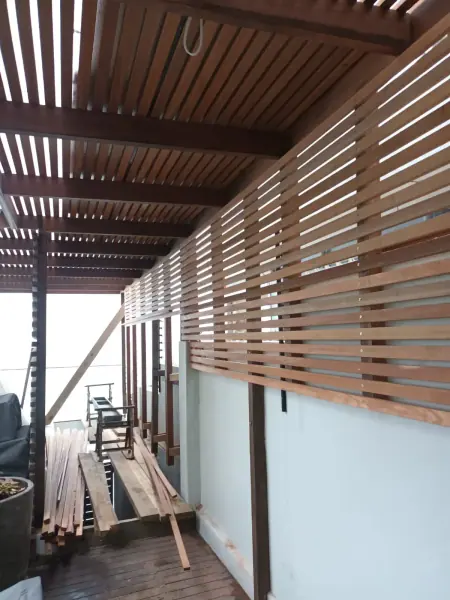 Horizontal timber slat balustrade beneath a covered deck