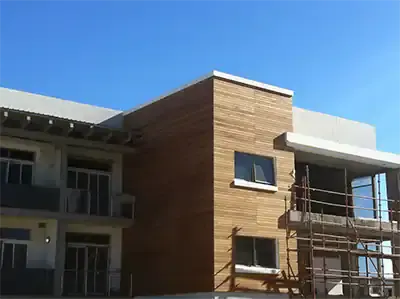Timber-clad upper storey of a multilevel building