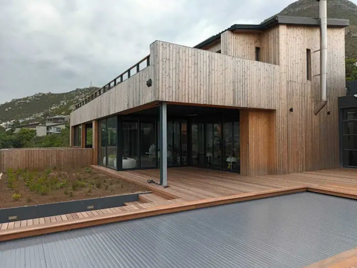 Contemporary home with vertical timber cladding beside a pool