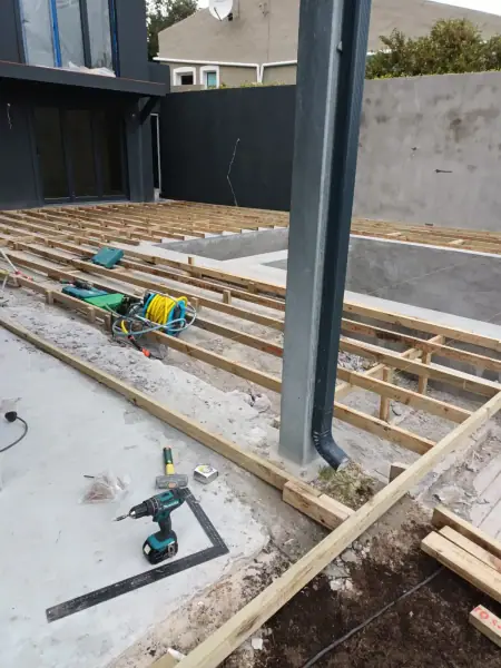 Structural groundwork and support post during an outdoor renovation