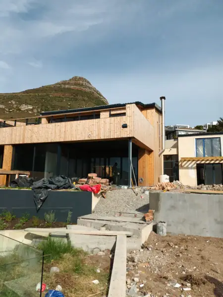 Home renovation site with a timber-clad upper floor