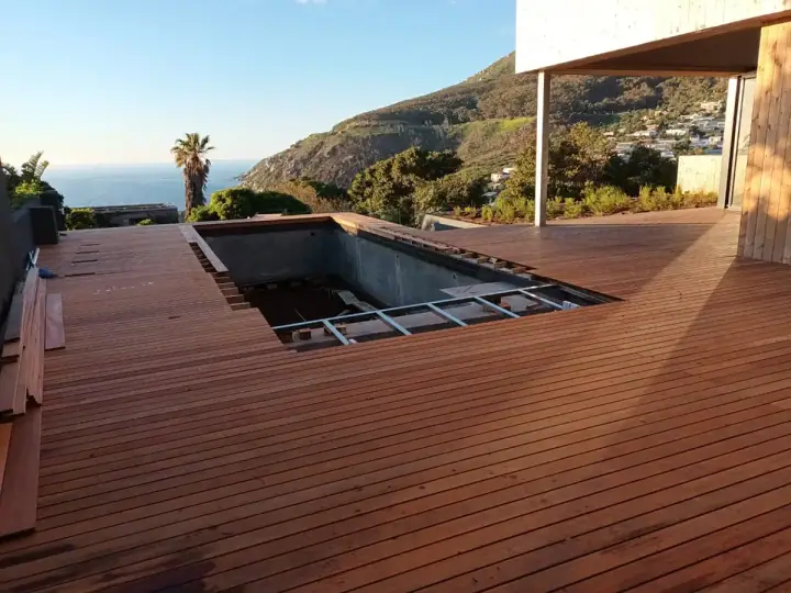 Completed timber decking surrounding a recessed swimming pool
