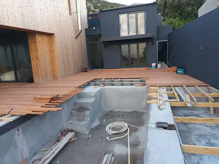 Timber deck under construction beside a contemporary home