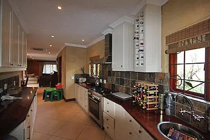Kitchen renovation with light cabinets and dark counters