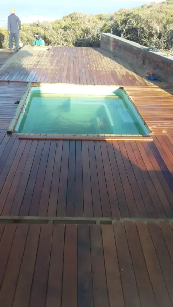 Long timber deck leading toward a small pool