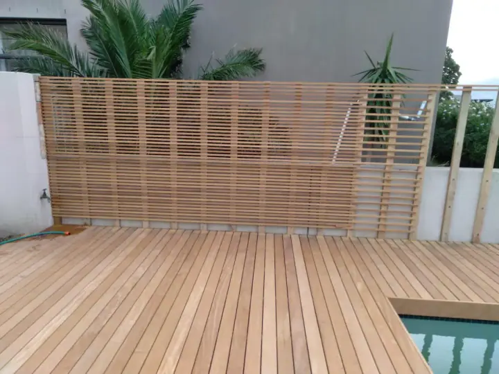 Close view of a timber screen beside a pool deck