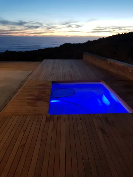 Timber pool deck photographed at dusk