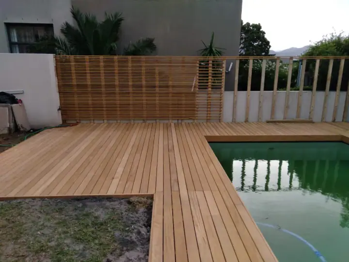 Timber deck and screen beside a swimming pool