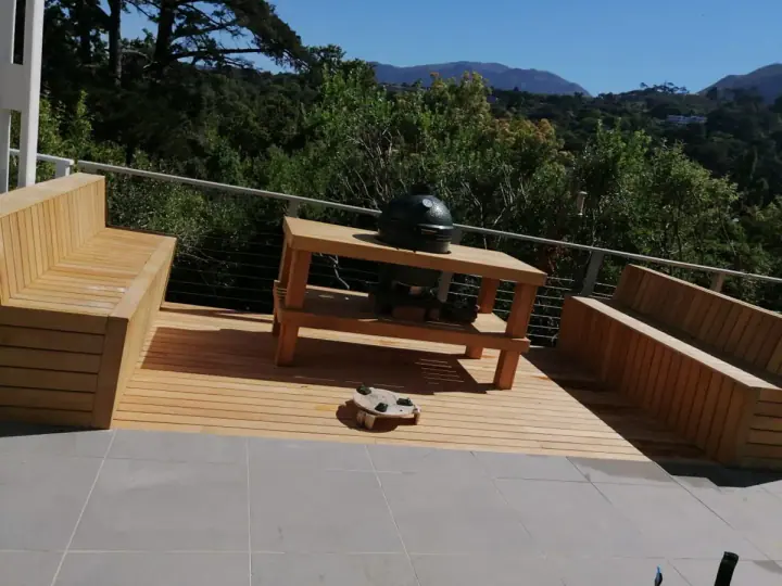 Raised timber deck with outdoor seating and garden views