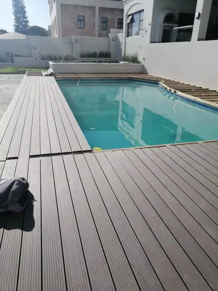 Timber boards around a compact courtyard pool