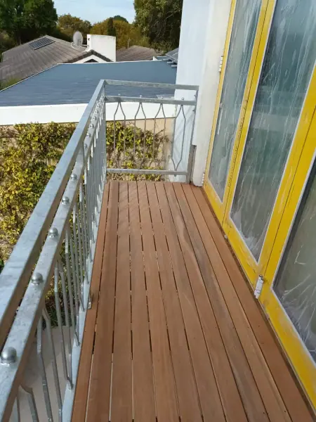 Narrow timber deck along the side of a home