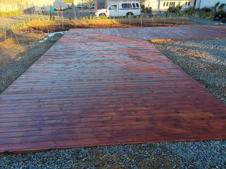 Broad timber walkway and deck in an outdoor landscape