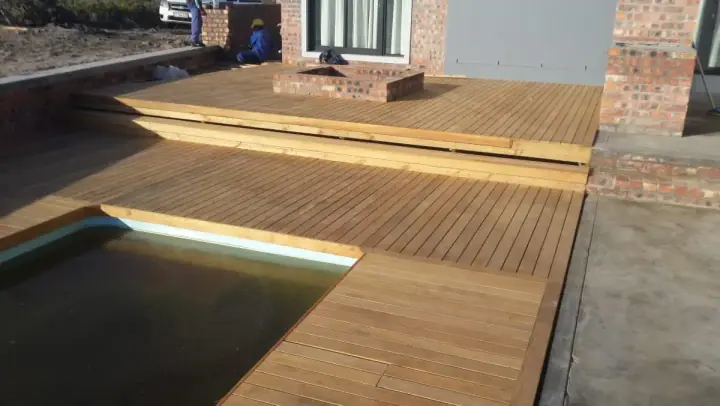 Timber deck and steps around a courtyard pool