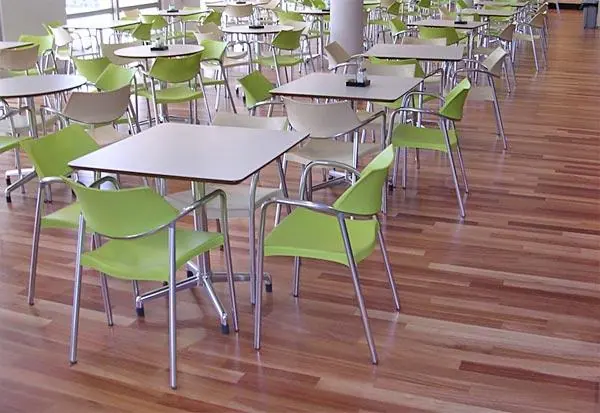 Striped timber flooring beneath cafe tables and chairs
