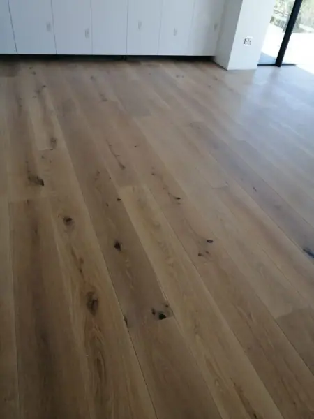 Pale timber floorboards running toward a doorway