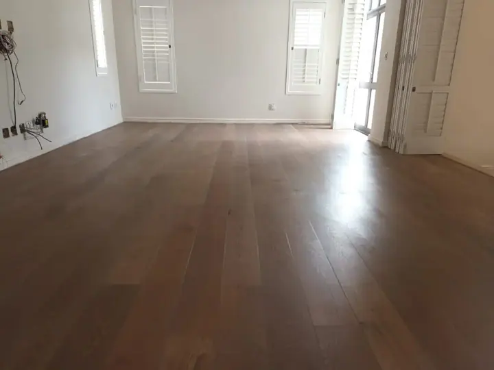 Warm timber flooring in an empty white room