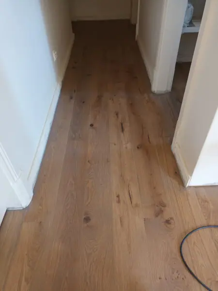 Timber floorboards in a narrow residential hallway