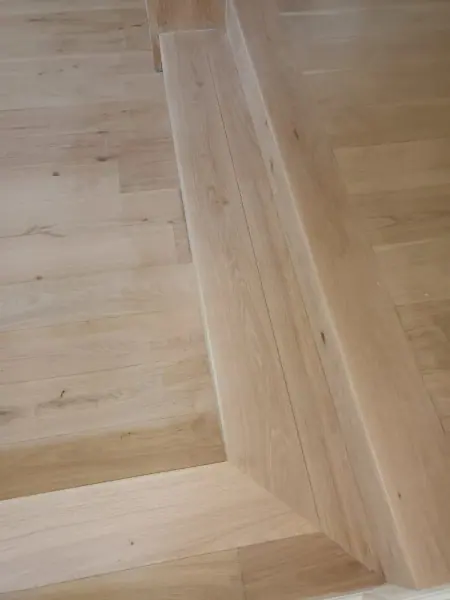 Close view of timber flooring beside a stair edge