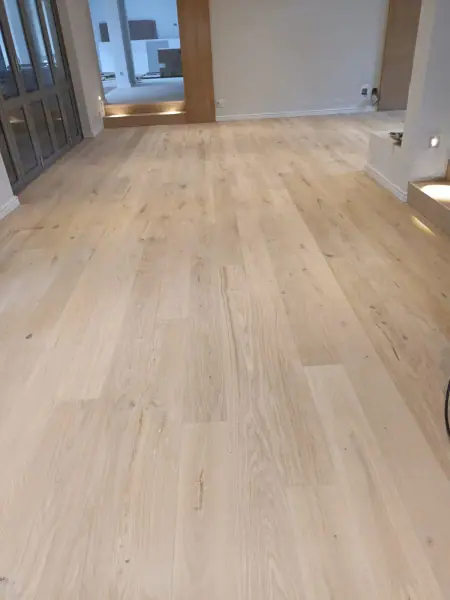 Light timber floorboards through a modern interior