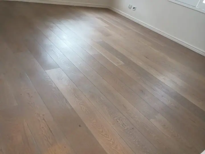 Smooth timber floorboards in an unfurnished room