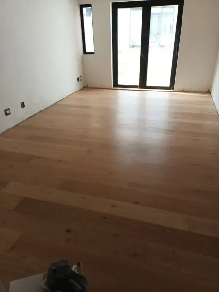 Timber flooring in a small room with glass doors