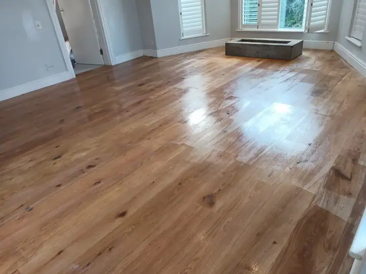 Glossy timber flooring in a bay-window room