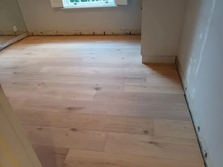 Timber floorboards in a compact unfinished room