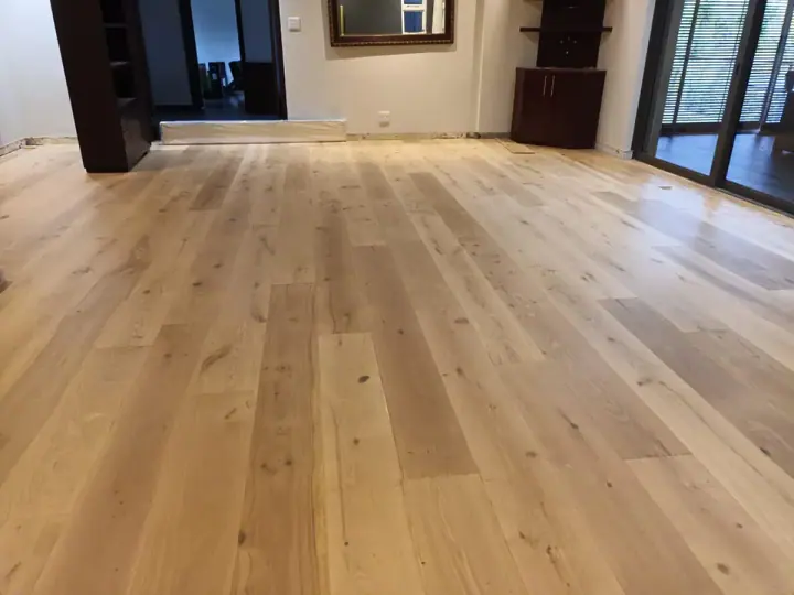 Pale timber floorboards in a large living area