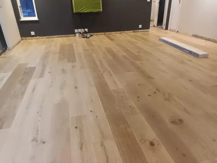 Long pale timber boards in an unfurnished room