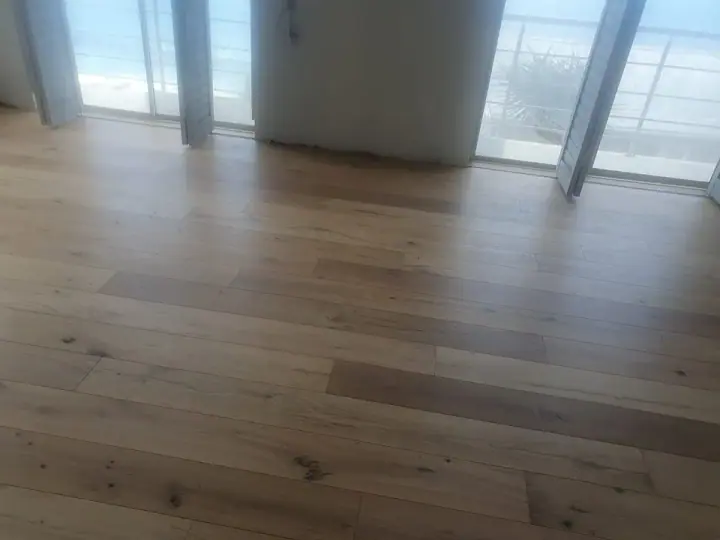 Timber flooring in a room with tall glass doors