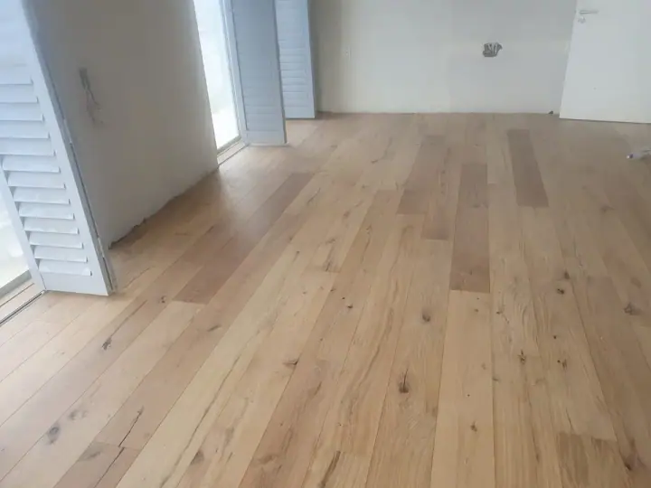 New timber floorboards across a bright interior
