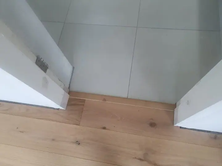 Timber floor meeting tile at an interior doorway