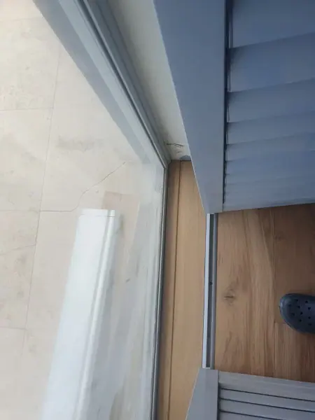Timber floorboards meeting a sliding glass door