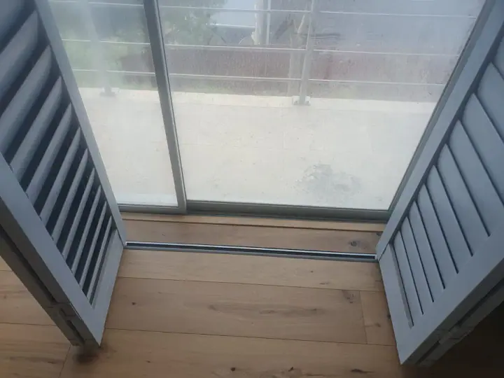 Timber flooring beside glass balcony doors