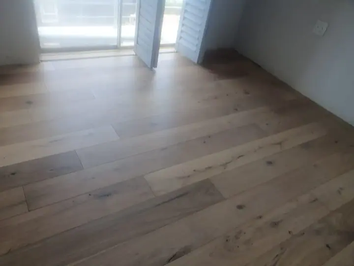 Pale timber floorboards in a bright empty room