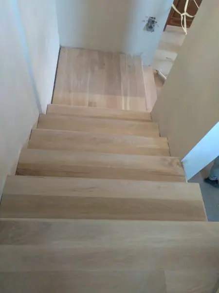 Pale timber stairs viewed down from a landing