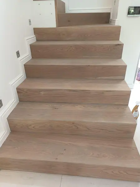 Straight timber staircase with pale finished treads