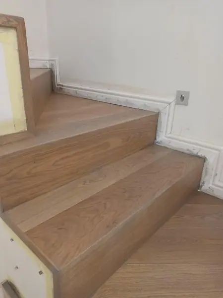 Pale timber steps with white wall trim