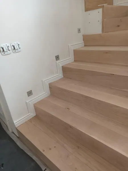 Timber stairs seen from the side at a landing