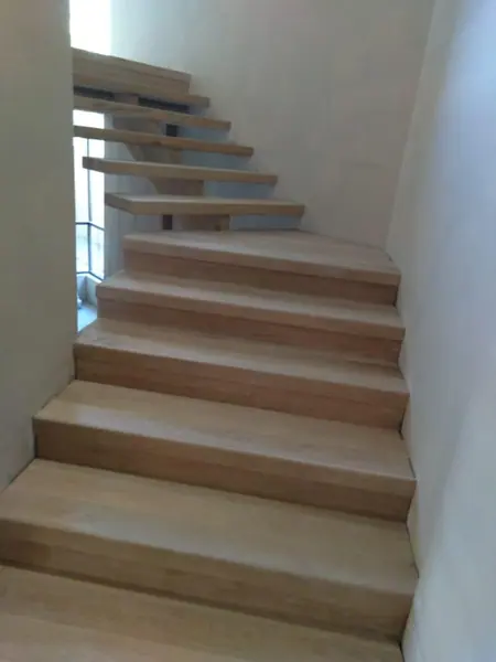 Pale timber staircase with open space below the treads