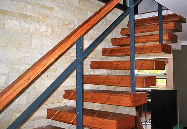 Open-riser timber staircase with a dark metal balustrade
