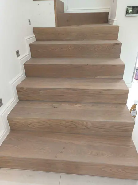 Pale timber stair treads in a white interior
