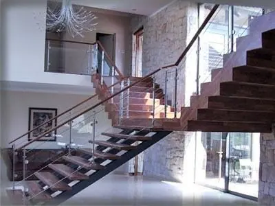 Open-riser staircase with a metal handrail