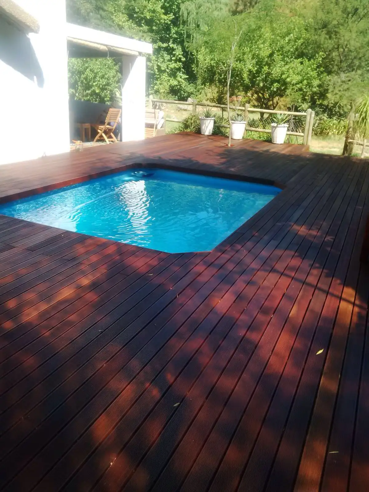 Dark timber decking surrounding a swimming pool